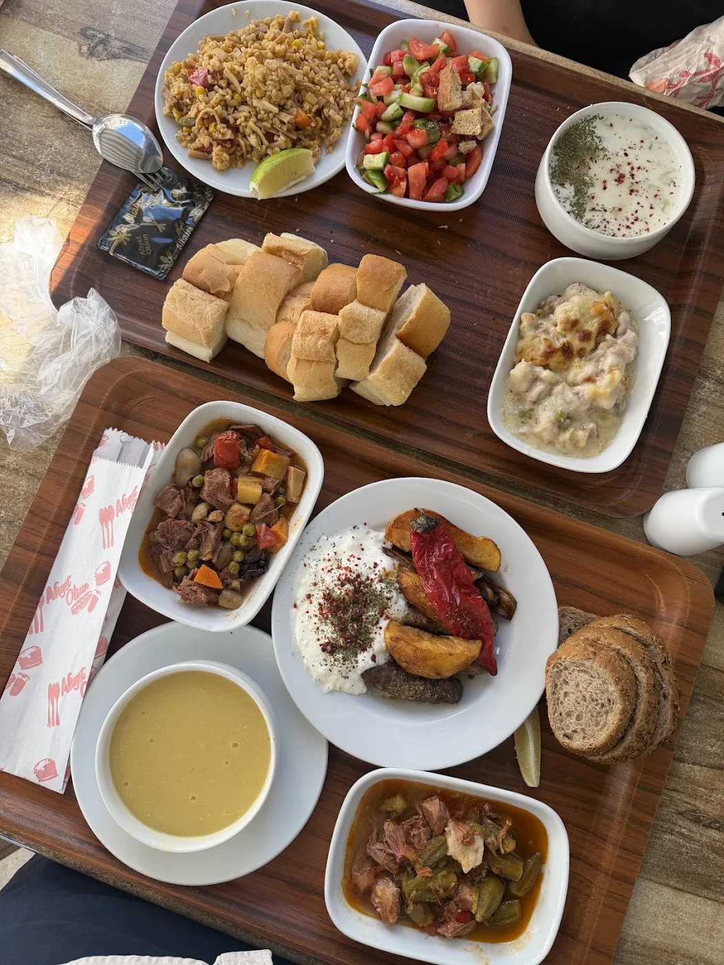 A full lunch tray with bread, soup and stews